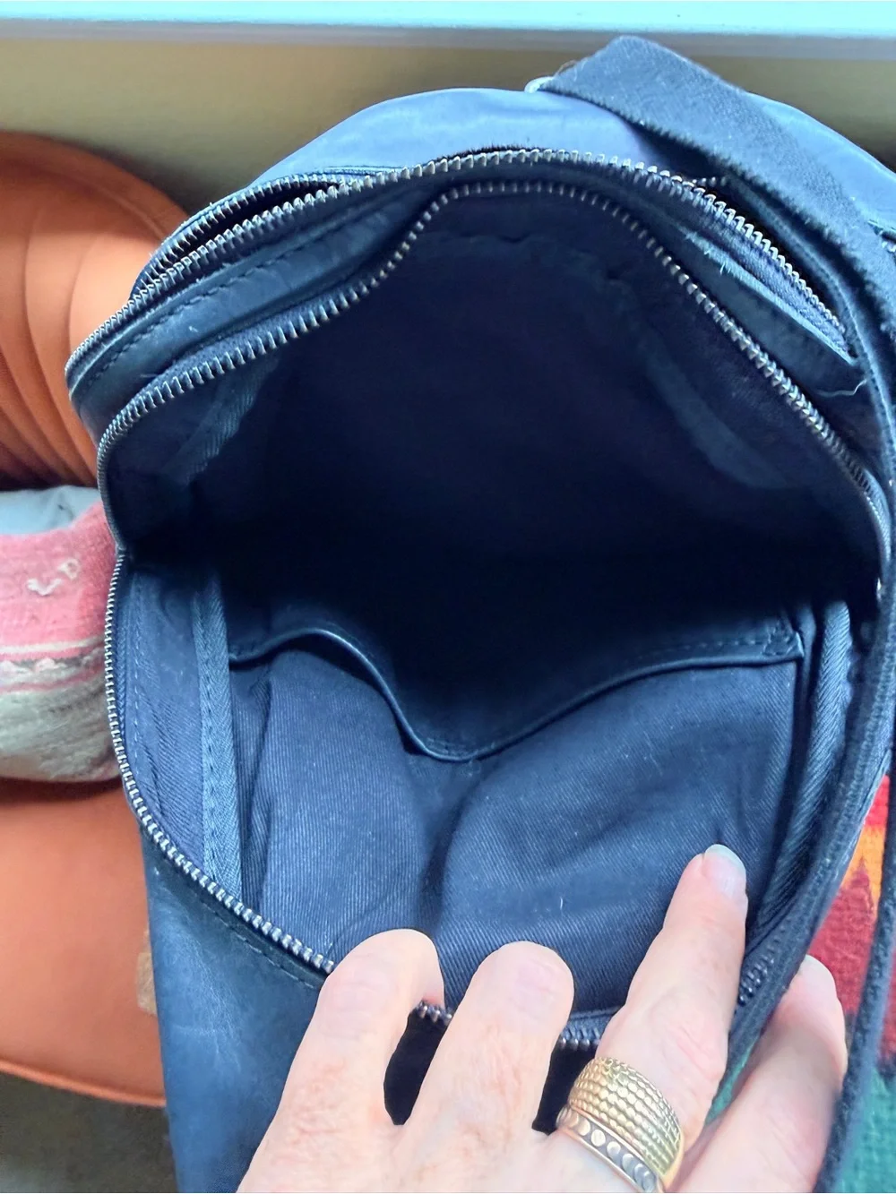 Black trianglular leather backpack with multiple pockets